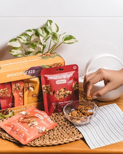 Amazin’ Graze granola bowl with fresh fruit and nuts styled for a wholesome Malaysian breakfast.